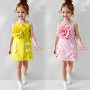 Detail of summer two-piece girls' set with 3D floral camisole and bow skirt