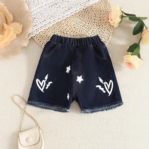 Close-up of girls' dark blue denim shorts with heart prints and frayed hem design