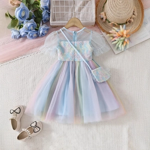 Detail of colorful rainbow tulle girl dress with floral embroidery and matching handbag