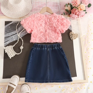 Detailed close-up of pink 3D rose short-sleeve top and blue denim skirt for girls