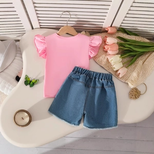Close-up of pink ruffle sleeve t-shirt and denim shorts with floral and butterfly details