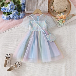 Detail view of 3D floral bodice and colorful rainbow tulle layers on the girls' dress
