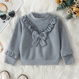 Close-up of a grey sweatshirt featuring elegant ruffle trim and a cute bow detail