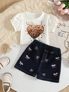 Girls summer outfit with white heart print t-shirt and blue bow pattern denim shorts