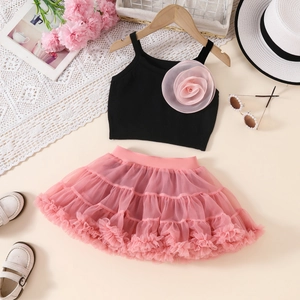 Detailed view of girls' black ribbed vest with pink mesh flower and layered tutu skirt