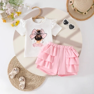 Detailed flat lay of a girls white flutter sleeve tee and pink layered shorts set