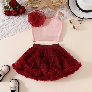 Detail of pink knitted camisole with large mesh flower and red tiered tutu skirt