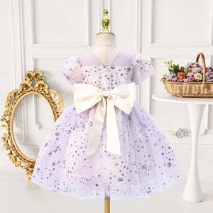 Detail of lavender sequin star girl dress with large satin bow and tulle skirt