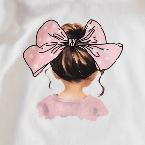 Close-up of girl with pink bow print on white cotton T-shirt fabric detail