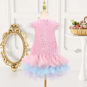 Detailed back view of girl's sequin gown featuring purple feathers and gradient tulle skirt