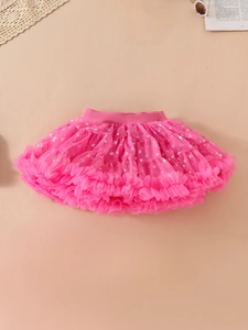 Pink girls tutu skirt with silver star patterns and tiered mesh ruffles in flat lay