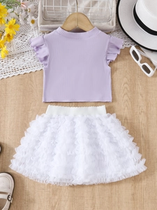 Detailed flat lay of girl's purple ribbed ruffle top and white tiered mesh tutu skirt