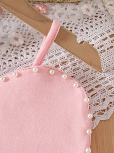 Pink girl's denim vest and shorts set with elegant pearl trim on wooden hanger