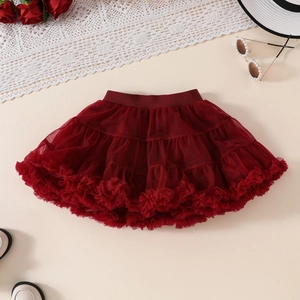Detailed view of burgundy tutu skirt with ruffled lace edges and layered tulle fabric