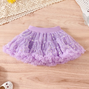 Detail of purple tutu skirt with gold star prints and layered soft mesh fabric
