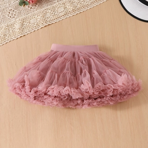 Detail of pink layered tulle tutu skirt with elastic waistband on wooden background