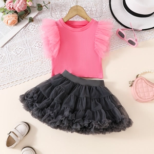 Detail of pink ribbed top with mesh ruffle sleeves and layered grey tutu skirt set