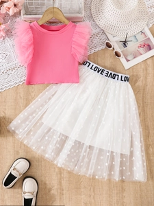 Set bambina con top rosa a costine e gonna in tulle a pois bianchi per l'estate