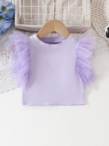 Detail of light purple ribbed knit top with ruffled tulle shoulders on a wooden hanger