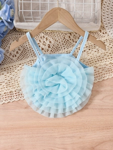 Blue mesh camisole top with 3D floral applique for girls on a wooden hanger