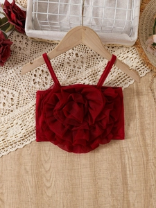 Girl's red camisole top featuring 3D mesh floral applique on a rustic wooden hanger