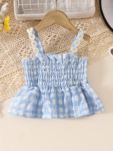 Girls blue gingham camisole top with daisy straps and smocked bodice on wooden hanger