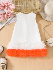 Detail of girls' white and orange layered mesh dress with a sleeveless design and round neck