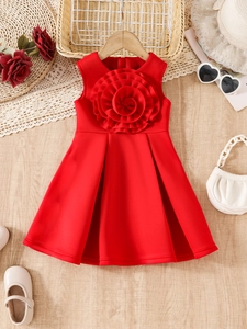 Detail of red sleeveless girls' princess dress with a large 3D layered floral applique
