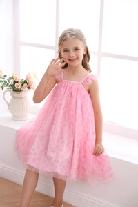 Detail of pink floral mesh dress for girls showing delicate shoulder ruffles and texture