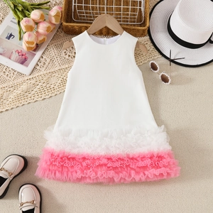 Flat lay of sleeveless white and pink gradient tulle dress with summer accessories