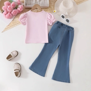 Flat lay of girl's summer outfit featuring pink puff sleeve t-shirt and denim flare pants