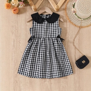Détail d'une robe vichy pour filles avec col Peter Pan noir et nœuds à la taille