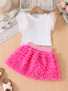 Detail of girls' summer set with white ruffled top and layered pink mesh tutu skirt