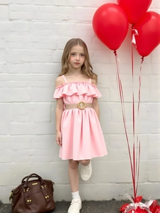Detail of pink off-shoulder girl dress with ruffle neckline and woven belt detail