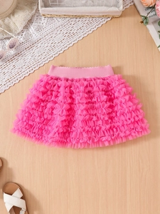 Detail of pink multilayered mesh tutu skirt with ruffled tiers and elastic waistband