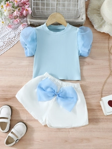 Girls summer set with light blue puff sleeve top and white shorts with a large bow