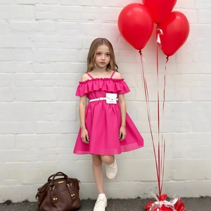 Detail of girls pink off-shoulder summer dress with ruffles, waist belt and mini bag
