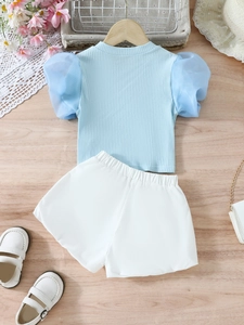Girls' summer set featuring light blue puff sleeve knit top and white elastic shorts