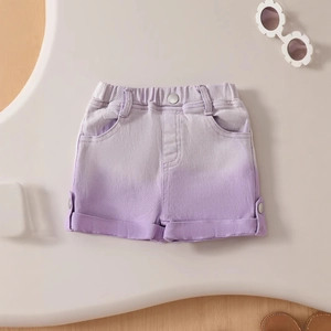 Detail of girls' purple gradient denim shorts with elastic waist and rolled hem