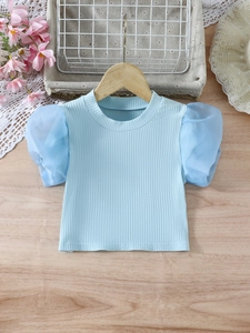 Girls sweet light blue ribbed t-shirt with mesh puff sleeves on a wooden background