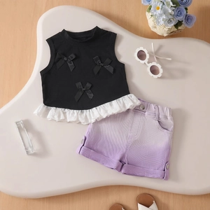 Detail of girls' black bow sleeveless top and purple gradient denim shorts set