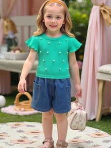 Girls bright green ribbed knit top with pearls and denim shorts two-piece summer outfit