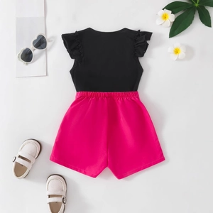 Girls summer outfit with black flutter sleeve heart tee and high-waisted rose pink shorts