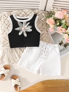 Girls black sleeveless vest with floral detail and white denim shorts summer set