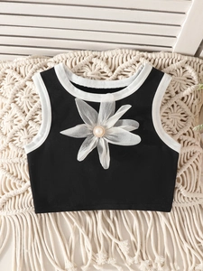 Girls black sleeveless crop tank top with a large white 3D floral and pearl decoration