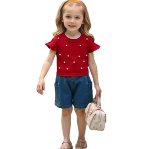 Girls red knit top with flutter sleeves and pearl beads paired with blue denim shorts