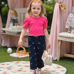 Detail of girls floral rose pink puff sleeve tee and embroidered bow jeans outfit