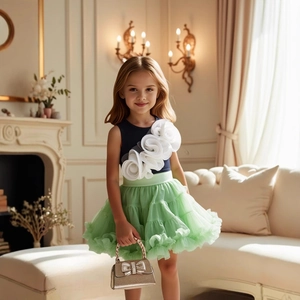 Detail of navy blue top with white mesh flowers and green tiered tulle skirt for girls
