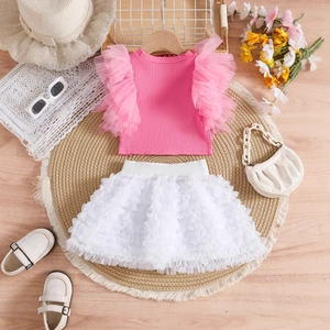 Detailed flat lay of a girls pink mesh sleeve top and white layered tutu cake skirt