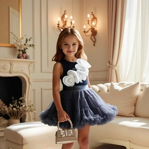 Close-up of girl in navy blue top with 3D white rose and tiered grey tulle tutu skirt